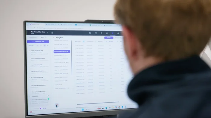 A team member viewing the Lupa analytics tables on a desktop monitor