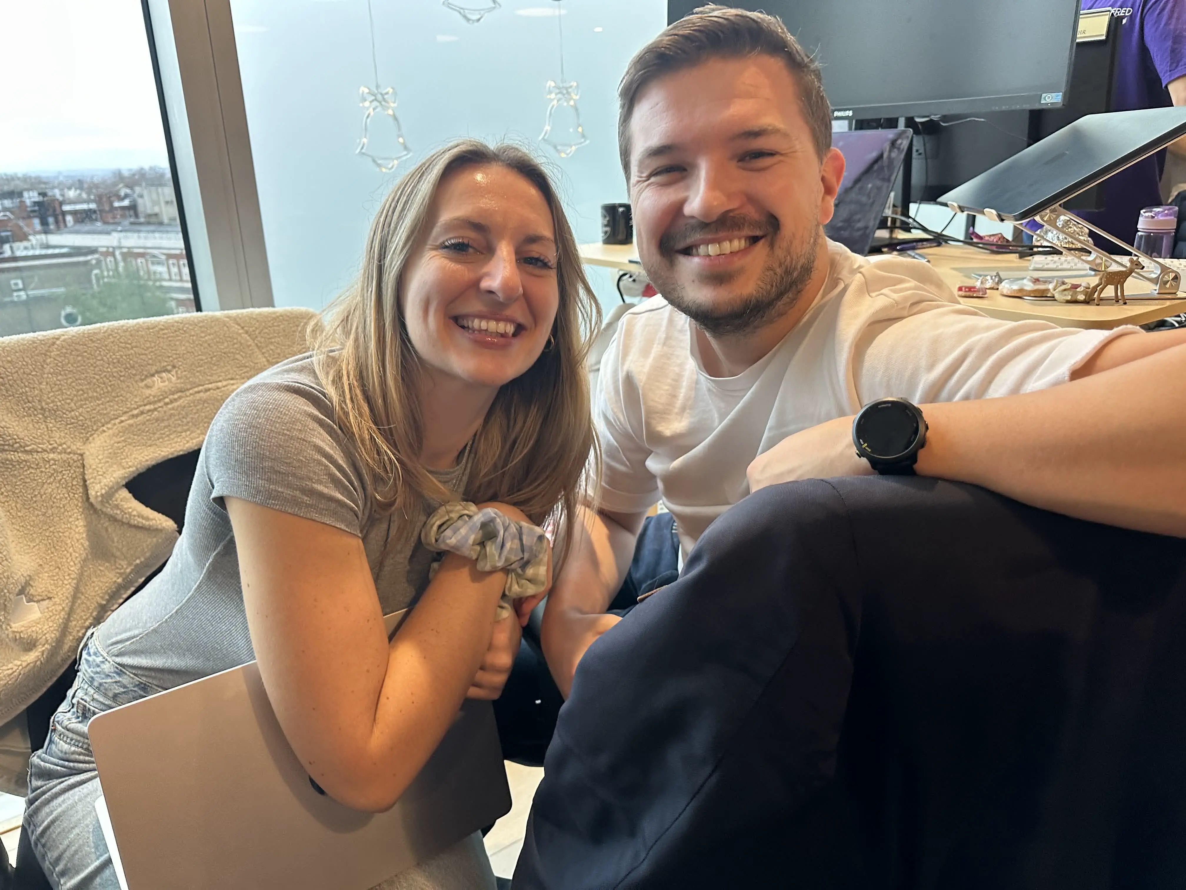 Two team members smiling